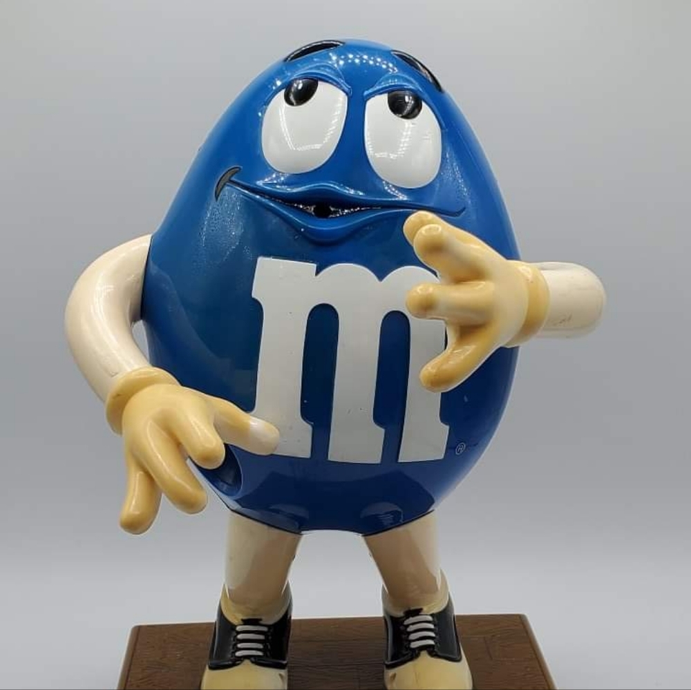 Blue M&M Dispenser as seen in pictures.  No saxophone or sunglasses